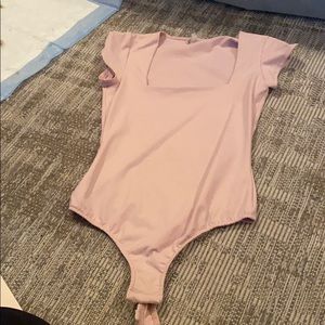Pink body suit
